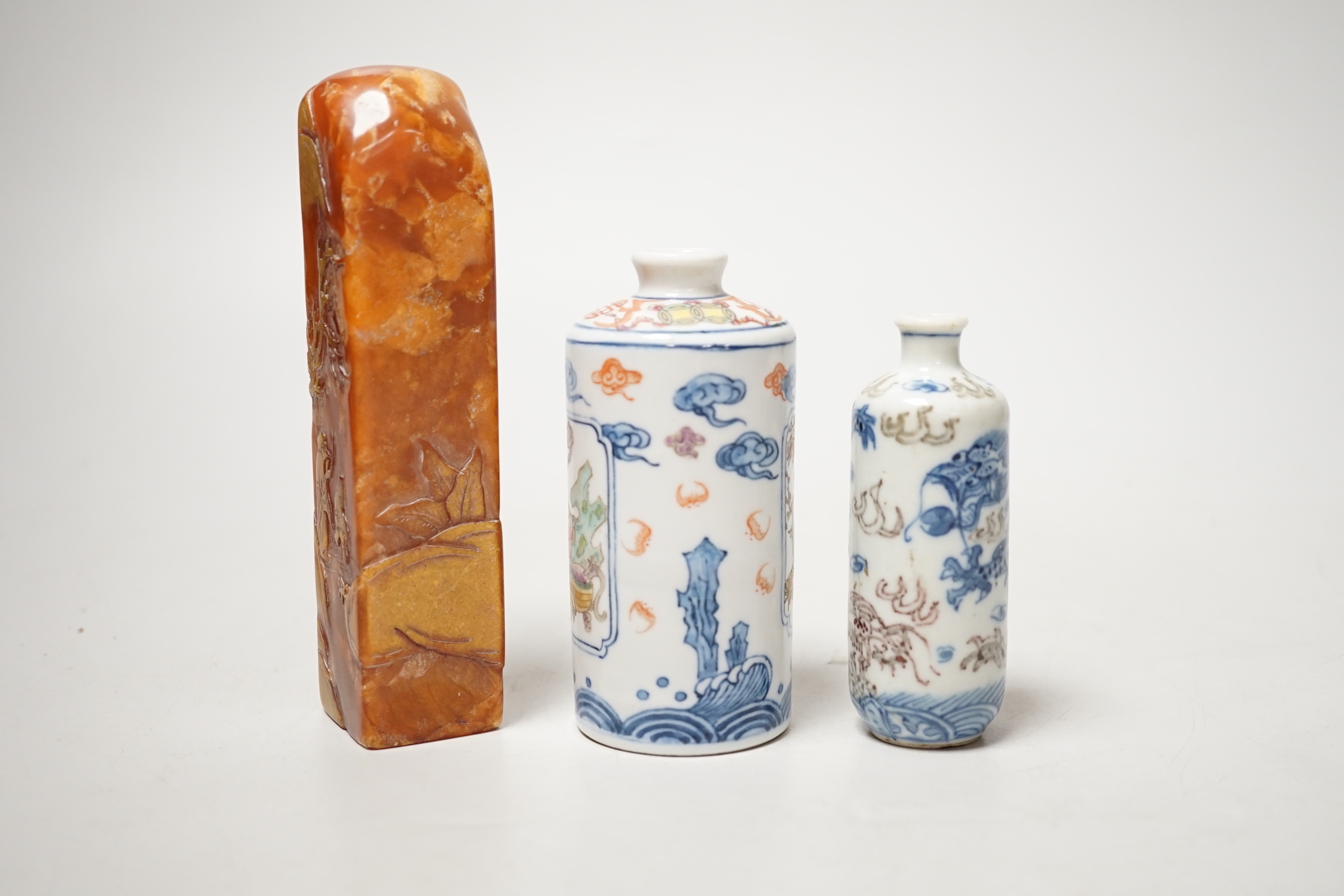 Two Chinese porcelain snuff bottles and a Chinese soapstone seal, 12.7cm